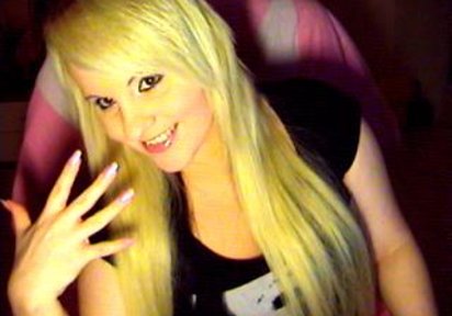 Stunning blonde camgirl SweetSimone with big passionate eyes and full magic lips poses on webcam.